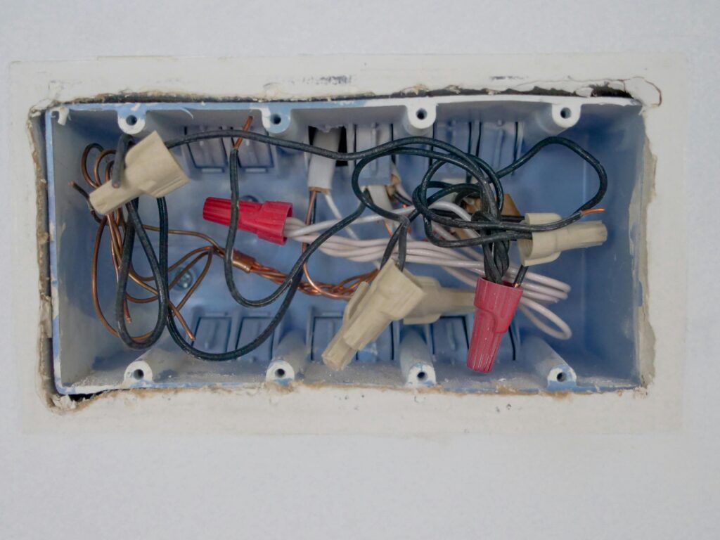 Detailed view of an opened electrical switchboard with visible wires and connectors.